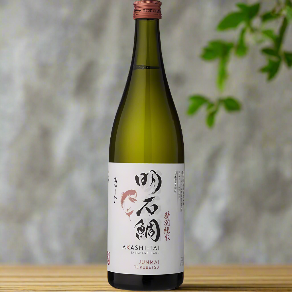 Akashi Tai Junmai Tokubetsu Sake bottle in serene Japanese garden with ceramics