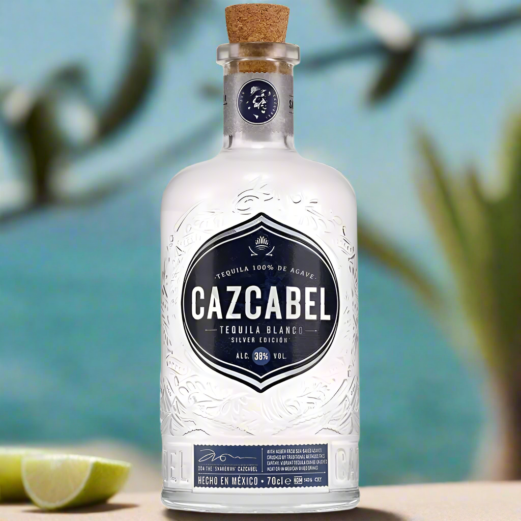 Cazcabel Tequila Blanco bottle on terrace with limes and agave