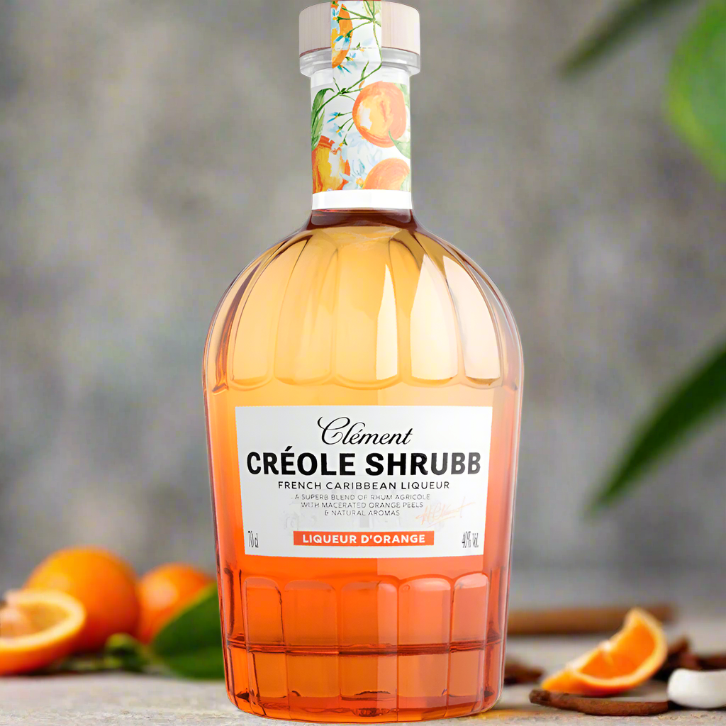 Minimalist Caribbean backdrop with orange peel, cinnamon sticks, and fresh citrus arranged on a light stone counter, blurred tropical foliage in background, soft natural light, no glass or people