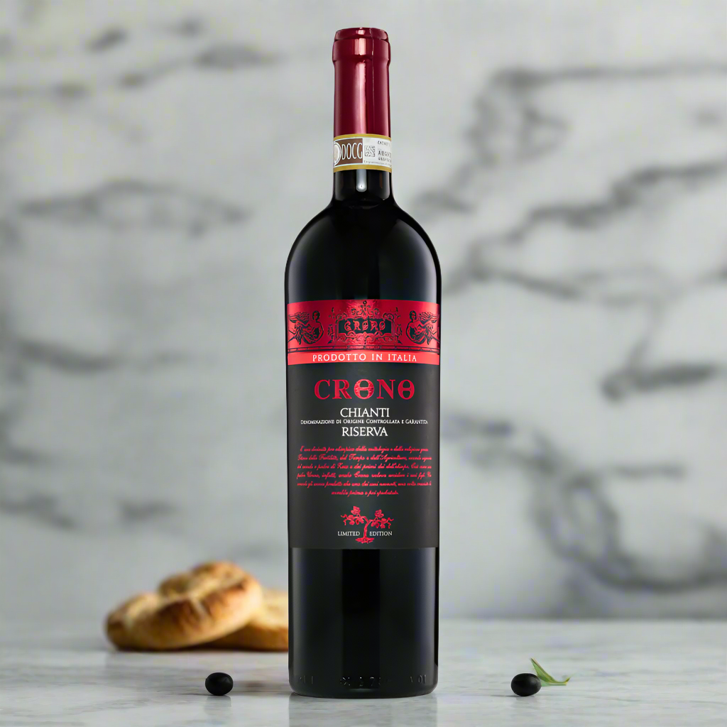 Chianti bottle on modern marble counter with basil, olives and bread in bright kitchen