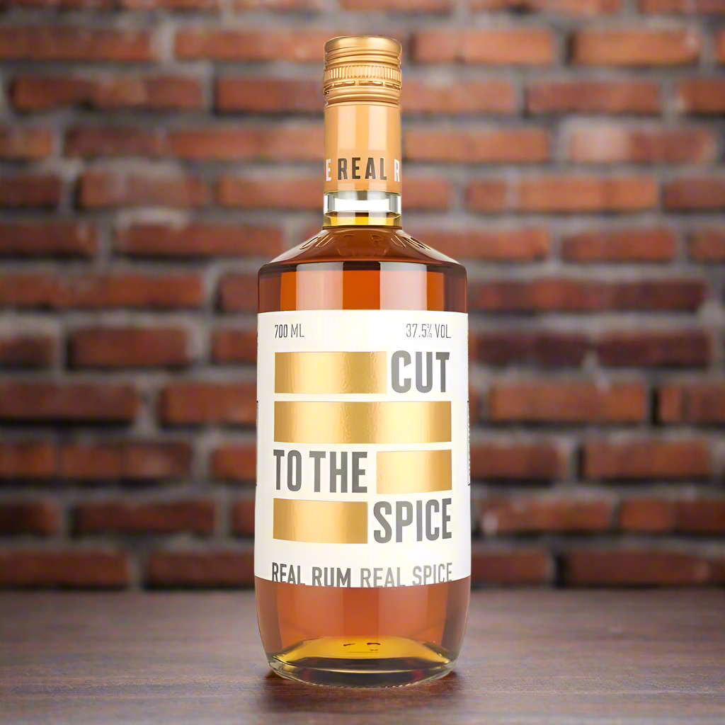 Moody Bar with Industrial Edge
A dimly lit bar scene with exposed brick walls, worn wood, and metal fixtures. The bottle of Cut To The Spice Rum sits on the bar alongside a short glass with ice and a twist of orange or cinnamon stick. Subtle hints of smoke or candlelight add drama, making the scene feel gritty and modern—perfect for a rum that doesn’t follow the rules.
