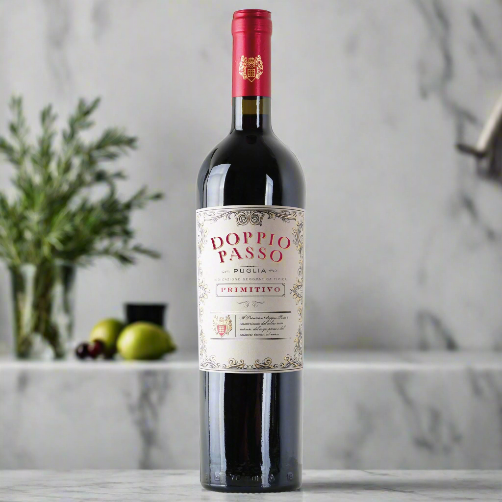 Doppio Passo Primitivo IGT Puglia bottle on marble counter with olives and rosemary