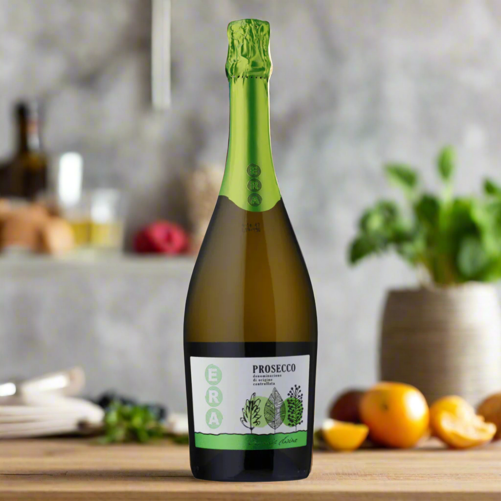 Bright eco-styled kitchen with natural wood and stone accents, bottle of organic Prosecco beside reusable flutes, fresh fruit and herbs on a linen runner