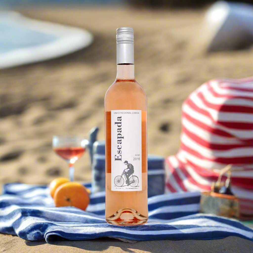 Beach Picnic on the Portuguese Coast
A relaxed beach picnic setup with a striped towel, sun hat, and a cooler bag holding the rosé. Light snacks, fresh fruit, and waves in the background set the tone for a refreshing, seaside escape.