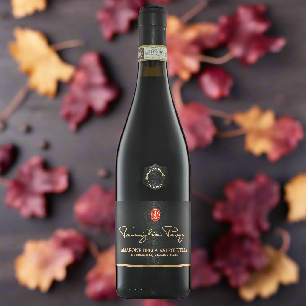 “Bottle of Famiglia Pasqua Amarone della Valpolicella on a rustic wooden table with dried grapes, autumn leaves, and dark chocolate. Warm, moody lighting, Italian countryside feel.”