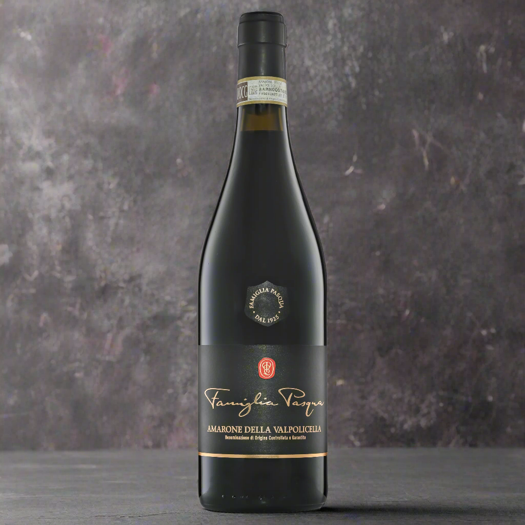 “Famiglia Pasqua Amarone della Valpolicella bottle on a dark stone surface with figs, cocoa nibs, and herbs. Minimalist, dramatic lighting with a sleek, contemporary backdrop.”