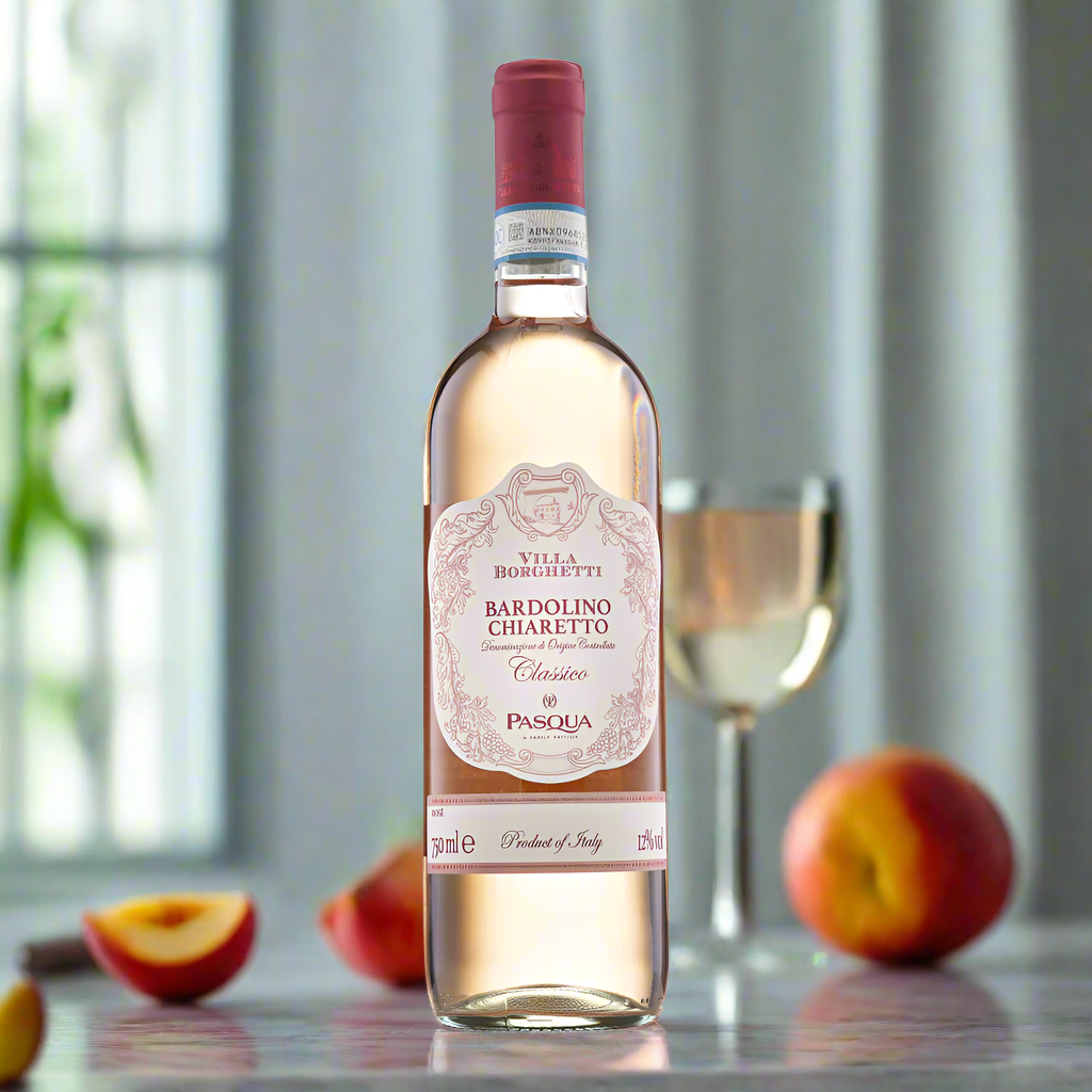 Rosé bottle on marble counter with peaches, mint, and morning light in modern kitchen.