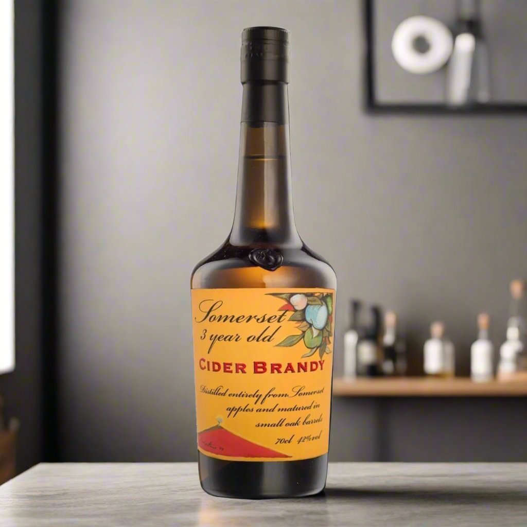 Contemporary home bar, matte black counter, bottle of cider brandy, glass with golden spirit, minimal decor, warm spotlight.
