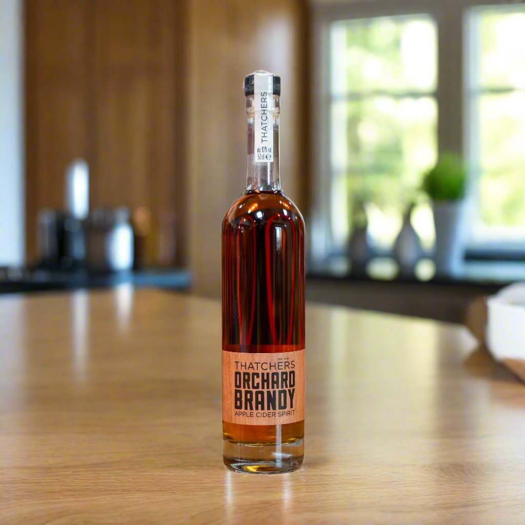 Thatchers Cider Orchard Brandy bottle on oak counter in bright kitchen