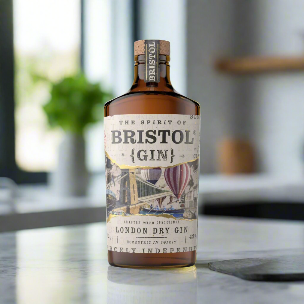 The Spirit of Bristol London Dry Gin bottle on marble kitchen counter with lemons and basil in a bright modern flat
