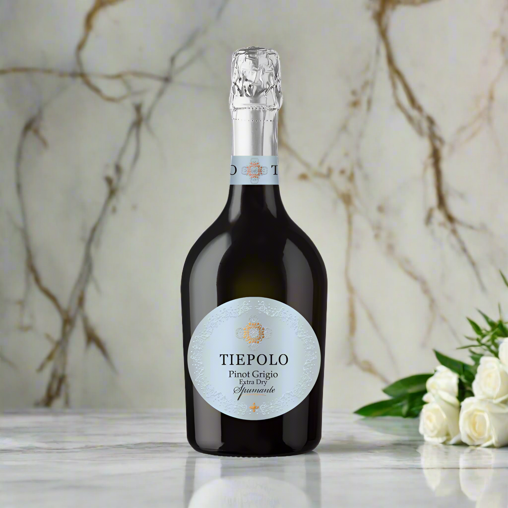 Bottle of Tiepolo Sparkling Pinot Grigio with white flowers on a marble surface