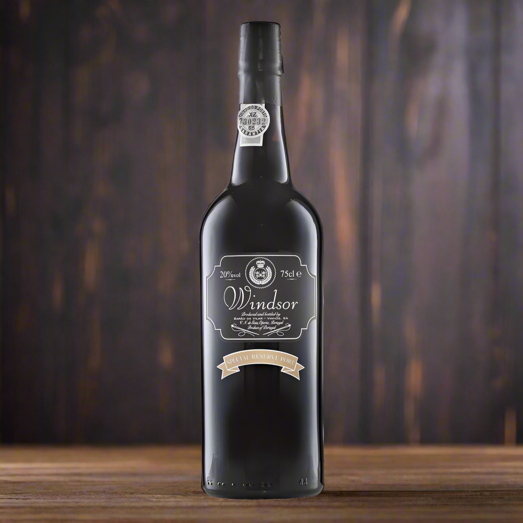 Bottle of Windsor Special Reserve Port on a dark wooden table with moody lighting.