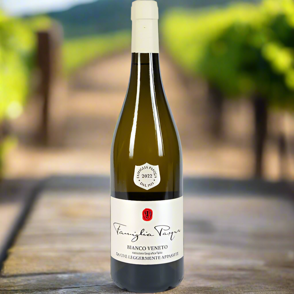 Bottle of Famiglia Pasqua Passimento Blanco with a blurred vineyard background