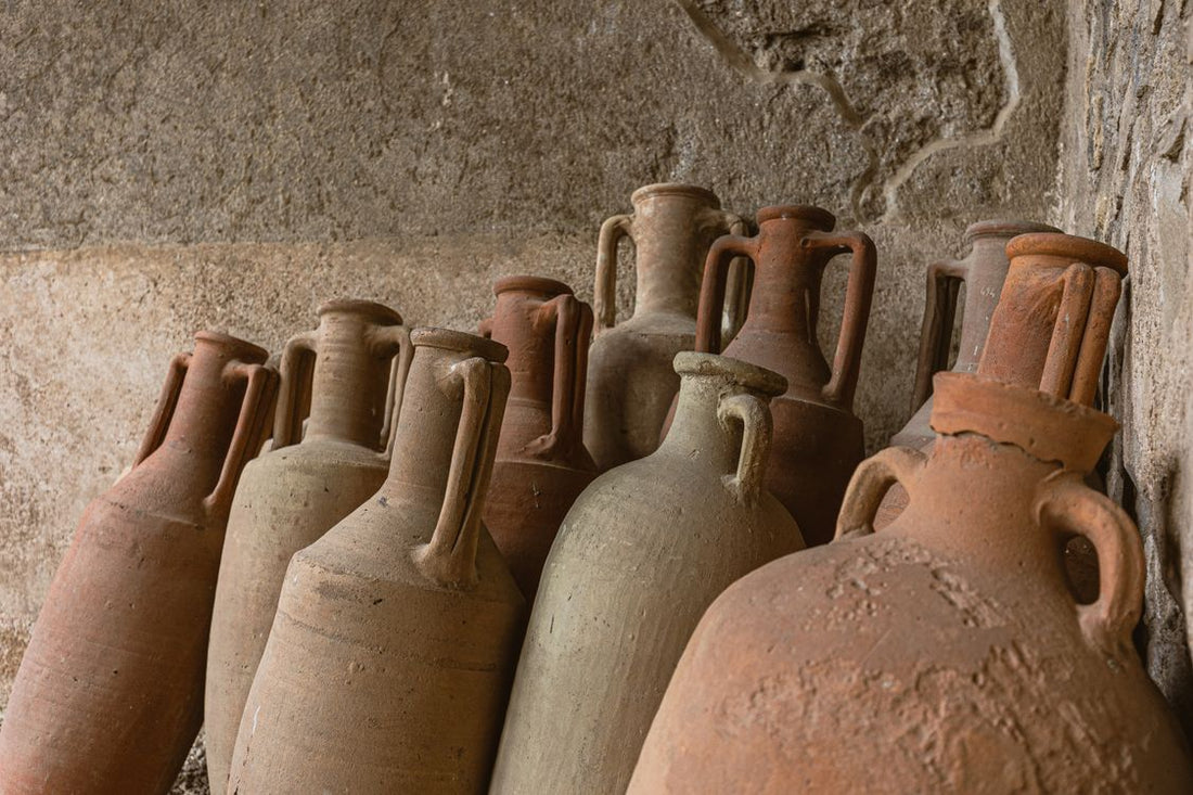 Ancient wine amphorae near a stone wall