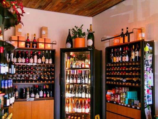 Wine shop display with bottles arranged on shelves