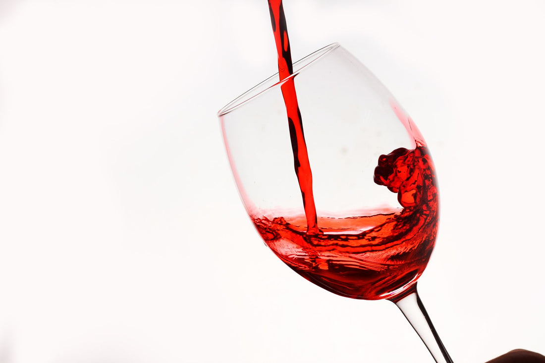 Close-up of red wine being poured and swirling in a glass