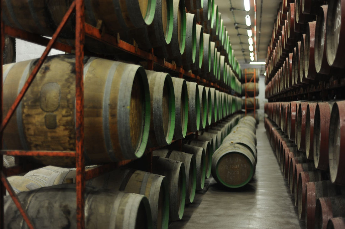 Wine barrels ageing in rows inside a traditional Spanish bodega wine cellar