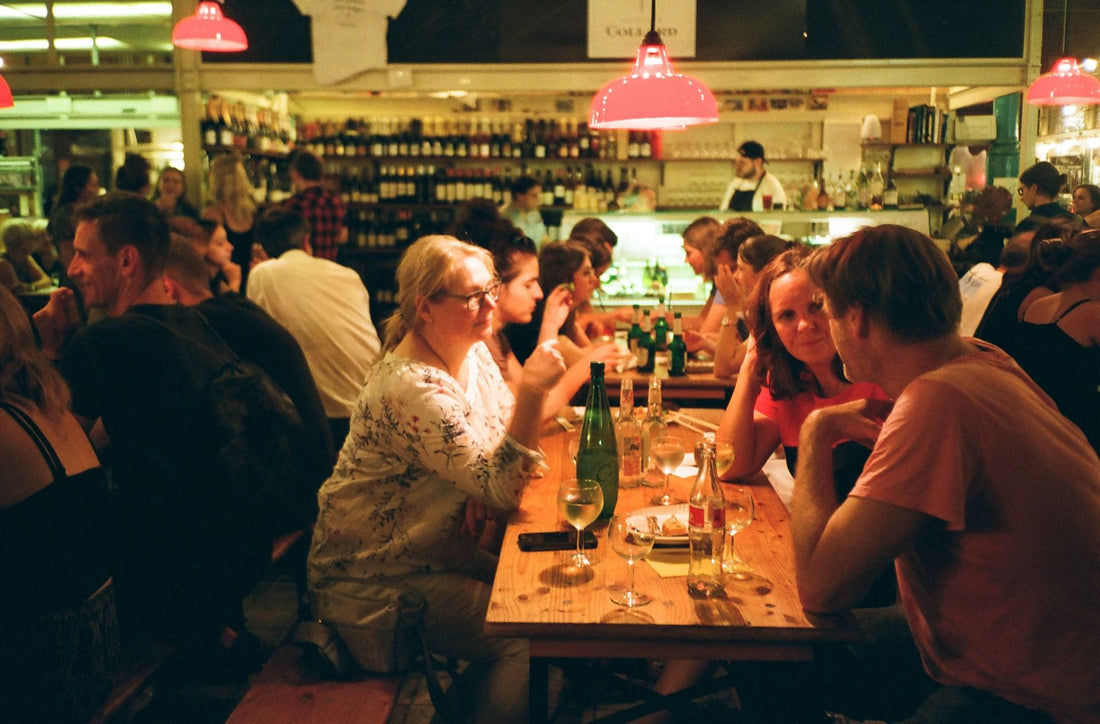 Wine tasting tables at a fair with guests sampling wines
