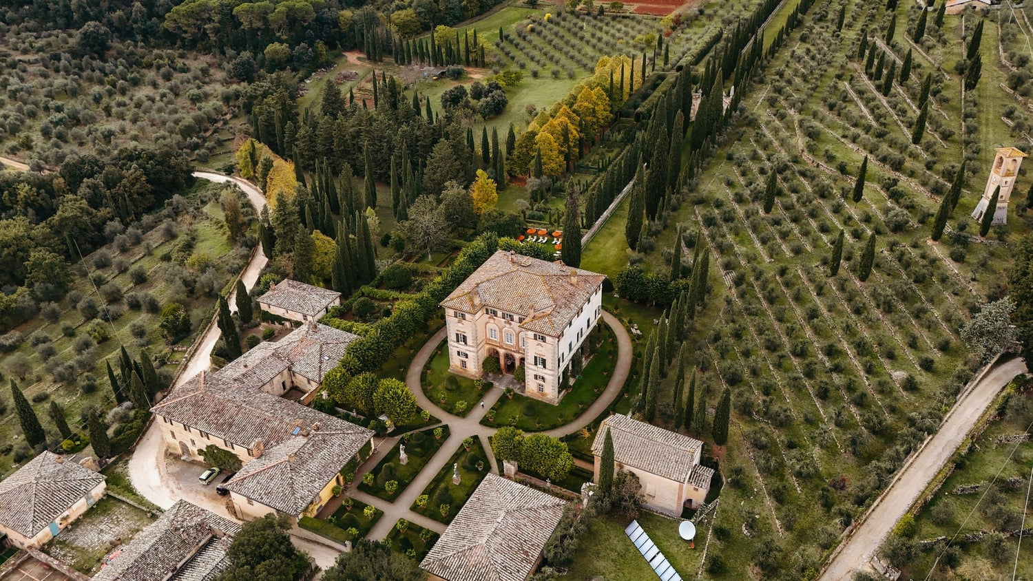 Aerial view of a grand estate villa with formal gardens, cypress-lined avenues and olive terraces — Bacalhoa Wines, Portugal