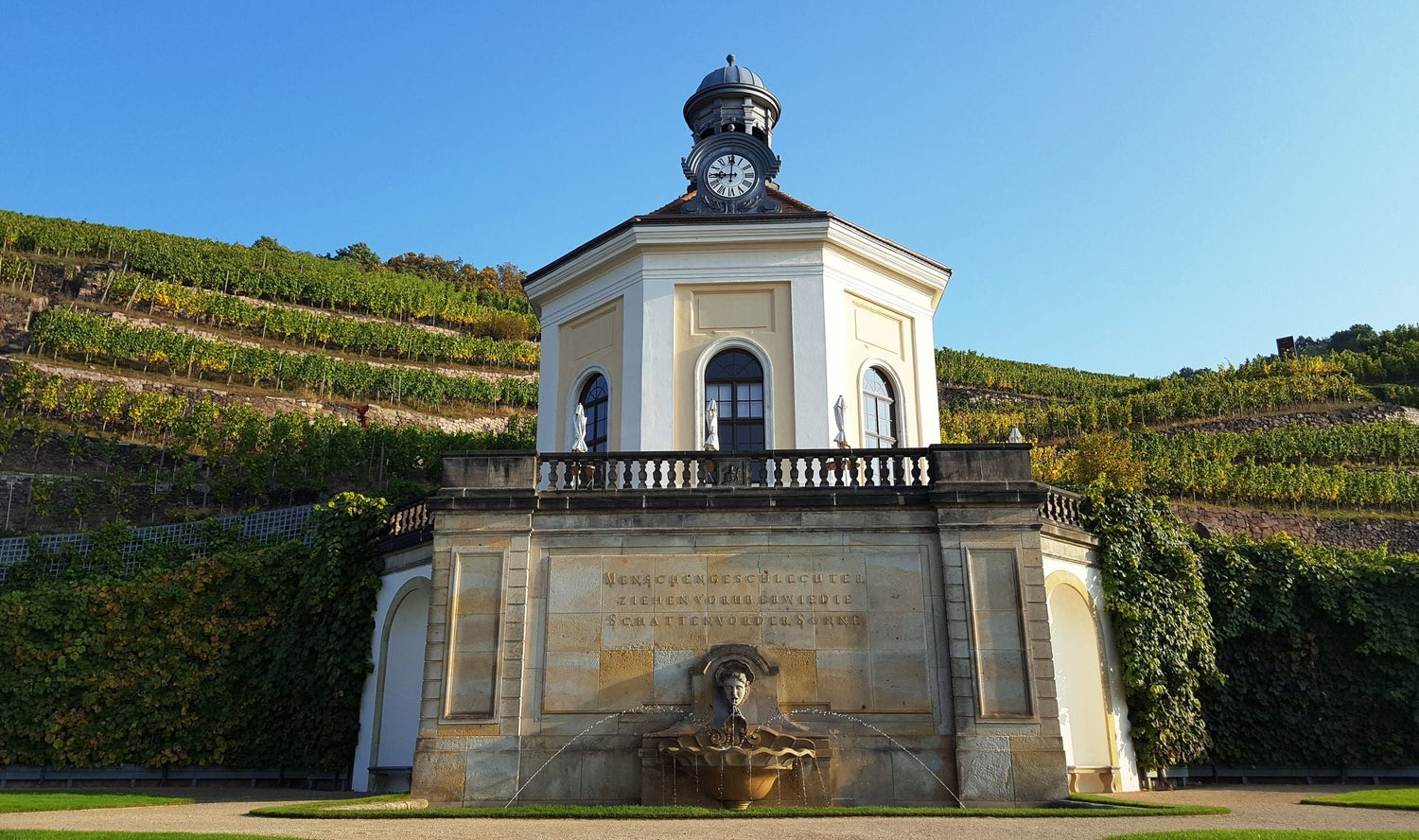 Baroque pavilion and fountain with terraced vineyards on the hillside above, Königs Cup wine estate