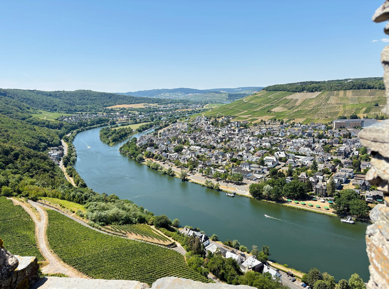 The Mosel River winding through steep vine-clad valley slopes and riverside wine villages, Mosel wine region, Germany