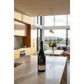 Akarua Pinot Noir Central Otago wine bottle displayed on a natural-stone kitchen island in a bright contemporary home.