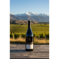 Akarua Pinot Noir Central Otago wine bottle displayed on a timber table overlooking vineyards and mountains in Central Otago, New Zealand.