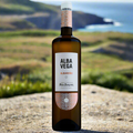 Alba Vega Albariño bottle on stone table overlooking the Galician coastline