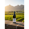 Babylonstoren Nebukadnesar wine bottle displayed on a stone terrace overlooking vineyards and mountains in South Africa’s Cape Winelands.