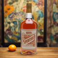“A vintage Italian bar scene with a bottle of Quaglia Aperitivo Berto on a rustic wooden counter, surrounded by citrus fruits, herbs, and an antique cocktail glass with an orange twist. Warm natural lighting, nostalgic 1950s Italian atmosphere, tiled backdrop.”