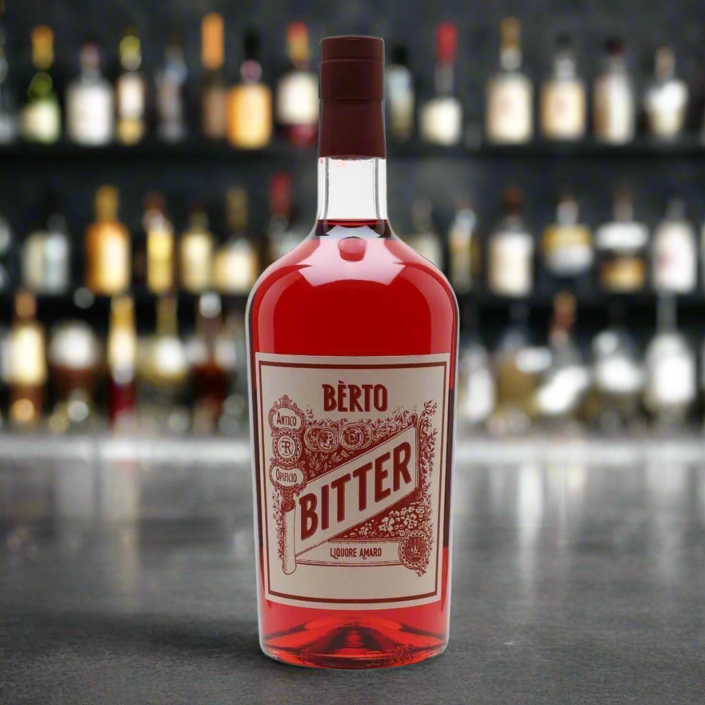 “A stylish cocktail bar scene with Quaglia Bitter Bèrto on a dark stone counter, next to a perfectly garnished Negroni in a crystal glass, orange peel, ice cubes. Moody lighting, sleek, contemporary vibe.”