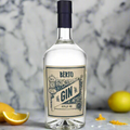 “Bèrto Distilled Dry Gin bottle on a clean marble counter with scattered botanicals and citrus zest. Bright, minimalist background with a fresh, contemporary look.”