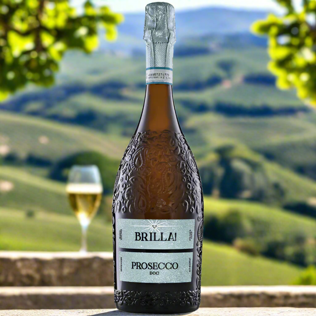 Brilla Prosecco Magnum on a stone terrace with lemons and olive branches, overlooking a sunny Italian vineyard.