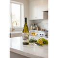 Chateau Montelena Chardonnay on a marble kitchen countertop with wine glass, fresh herbs and citrus