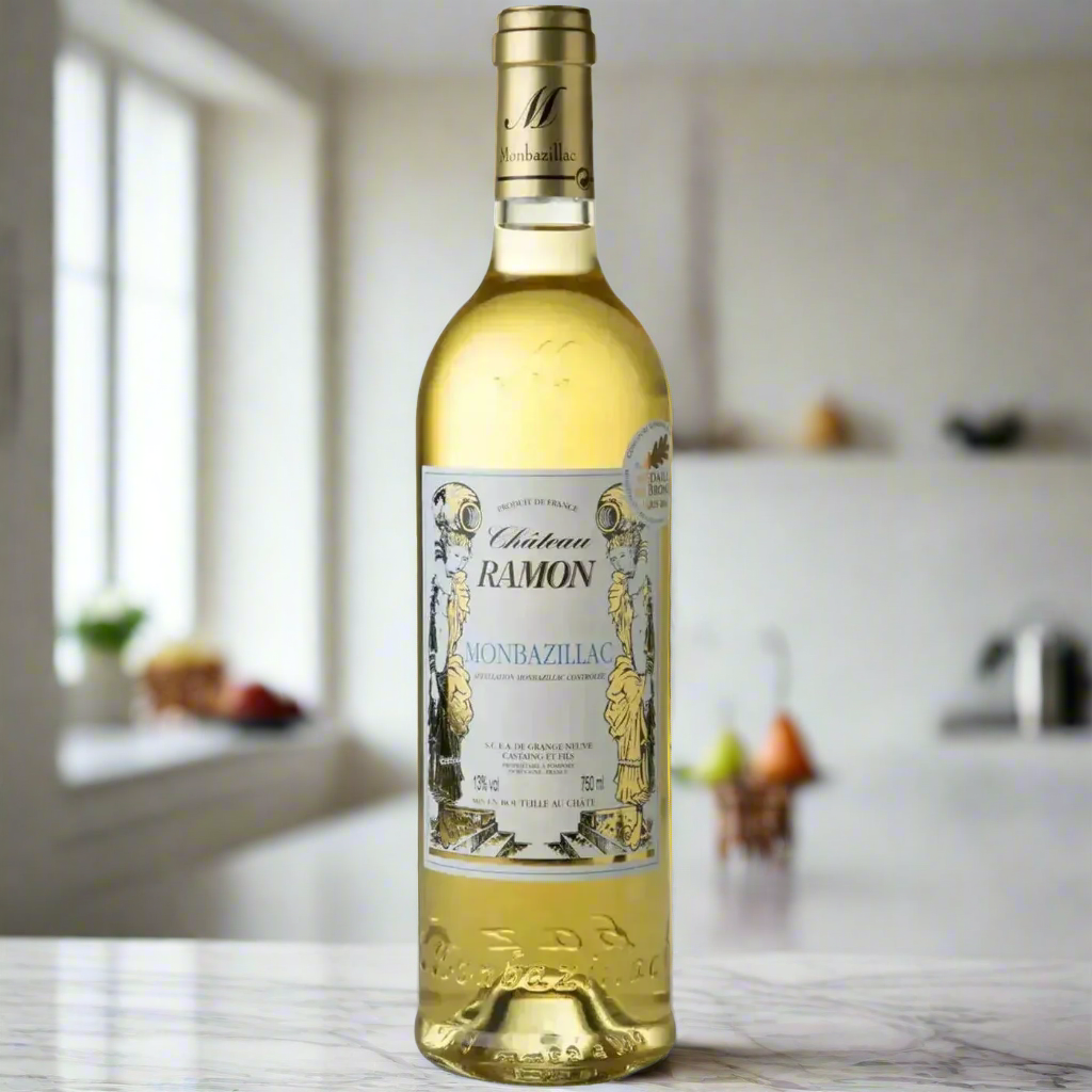 Château Ramon Monbazillac on marble counter with honey and pear in bright kitchen.
