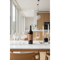 Clos du Val Cabernet Sauvignon bottle displayed on a contemporary dining table in a bright modern kitchen-dining space.