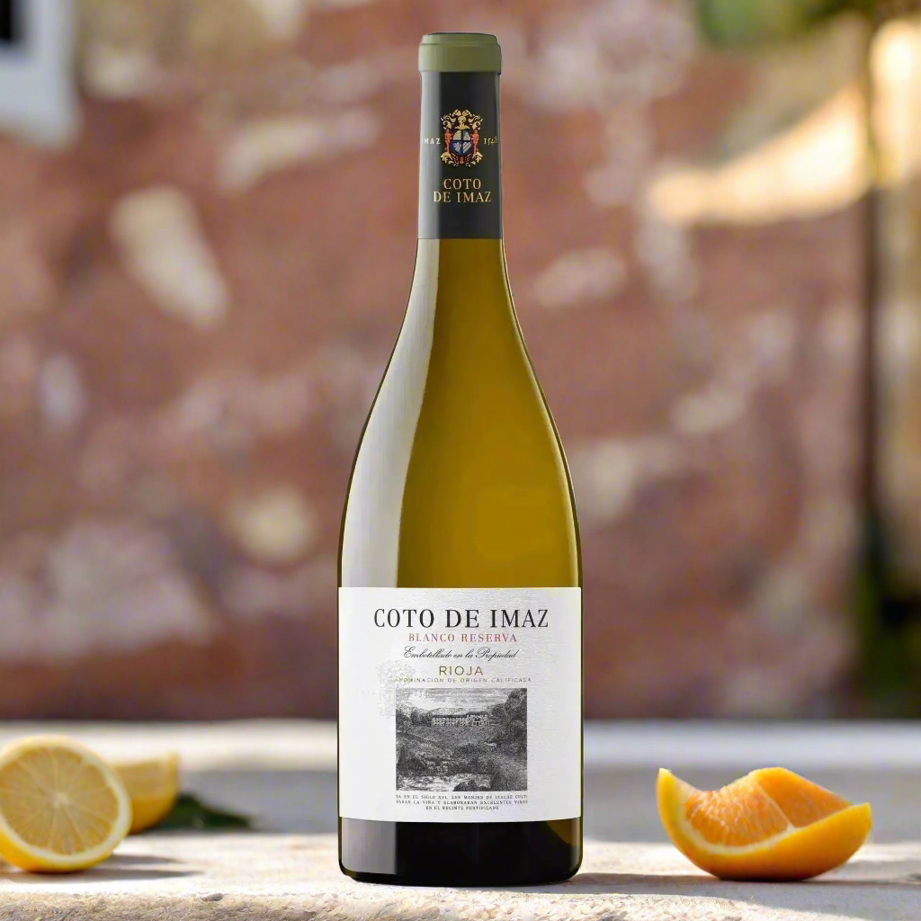 Coto de Imaz Blanco Reserva bottle in a sunlit Spanish courtyard with citrus 