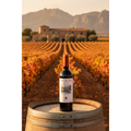 Coto de Imaz Rioja Reserva bottle displayed on an oak barrel overlooking Rioja vineyards at sunset.