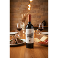 Coto de Imaz Rioja Reserva bottle displayed on an elegant dining table with Spanish cuisine and red wine glasses.
