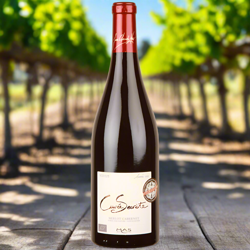 Cuvee Secrete Merlot Cabernet Sauvignon bottle on vineyard table 
