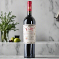 Doppio Passo Primitivo IGT Puglia bottle on marble counter with olives and rosemary