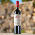 A bottle of Doppio Passo Primitivo IGT Puglia bottle on a stone wall  with blurred natural background
