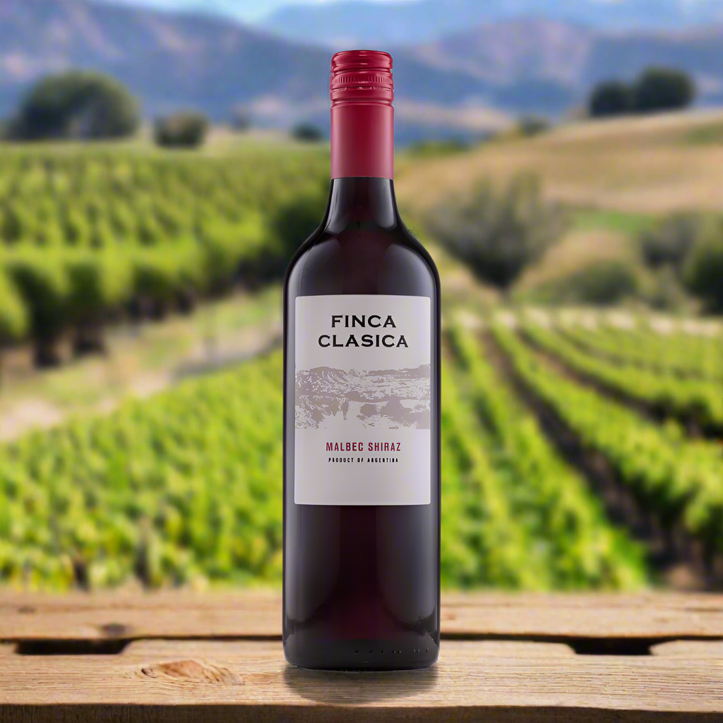 Finca Clasica Malbec & Shiraz bottle in vineyard setting with grapes and mountain view