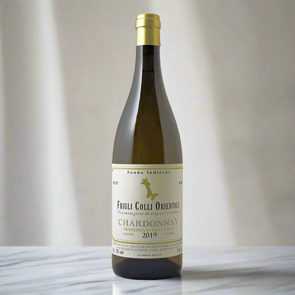 Fondo Indizeno ‘Monopolio Sannicola’ Chardonnay bottle on marble kitchen island with daylight.