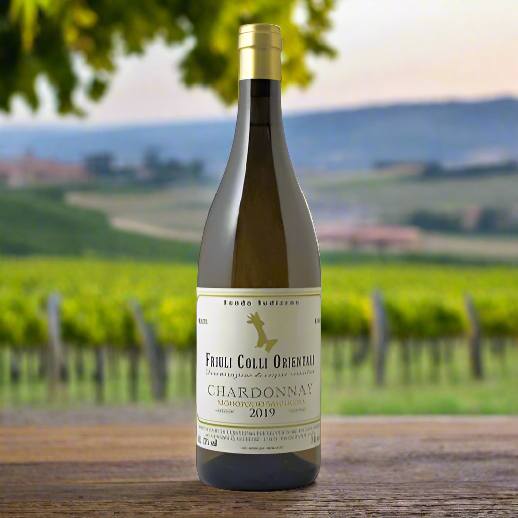 Fondo Indizeno ‘Monopolio Sannicola’ Chardonnay bottle with Friuli vineyard backdrop.