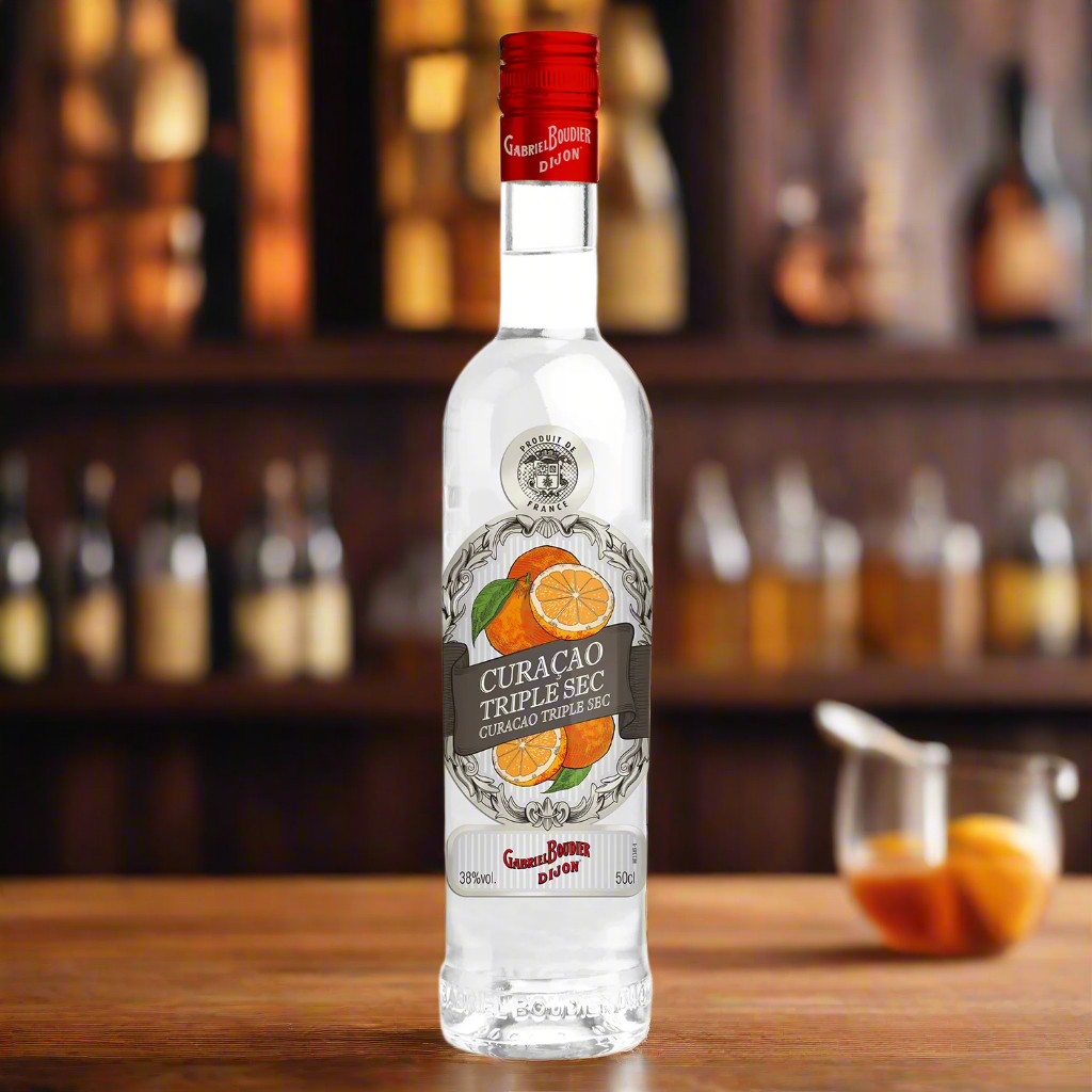 Classic wooden bar surface with vintage citrus fruits, copper bar tools, and an old distillery shelf blurred in the background, warm golden light creating a nostalgic French liqueur atmosphere