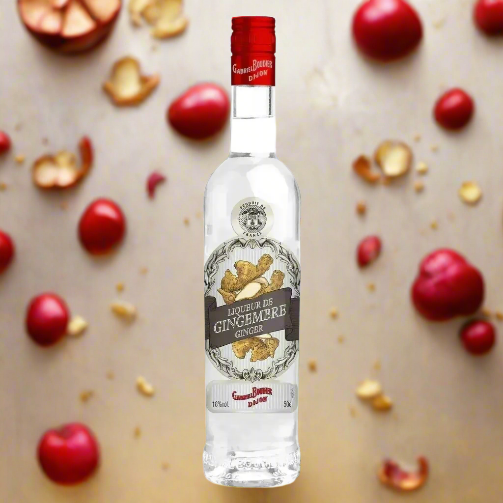 Gabriel Boudier Liqueur De Gingembre bottle with floating ginger slices and roots on golden background.