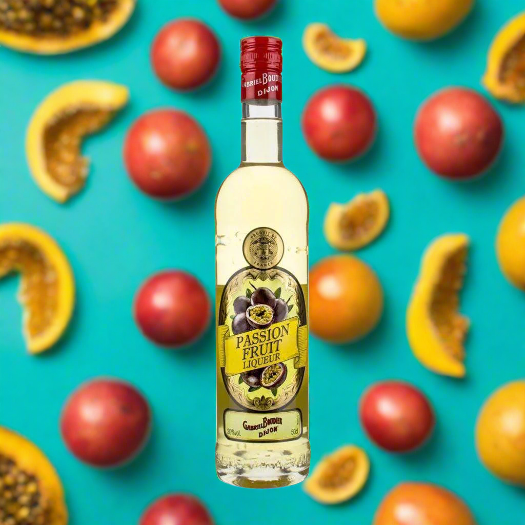 Gabriel Boudier Passion Fruit Liqueur with floating passion fruit slices on turquoise background.