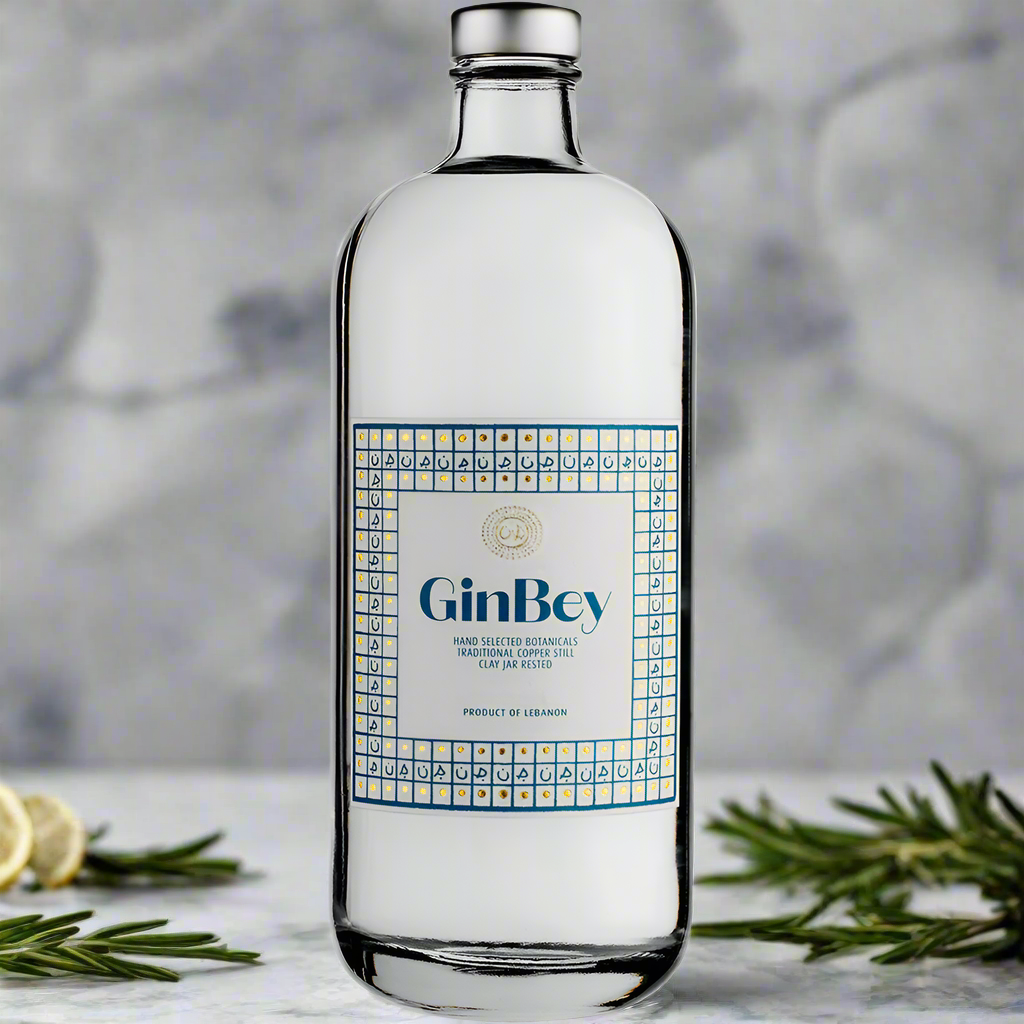 GinBey Gin bottle on marble counter with rosemary and lemon