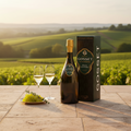 Gosset Grand Millesime Brut 2016 Champagne with Gift Box displayed on a terrace overlooking vineyards in the Champagne region at sunset.